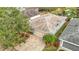 Aerial view of a well-maintained single-story home with a paver driveway and mature landscaping at 29523 Waggle Dr, San Antonio, FL 33576