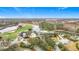 Elevated view of a community clubhouse nestled between a golf course, lake, and swimming pool at 29523 Waggle Dr, San Antonio, FL 33576