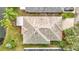 Overhead view showcases the roof and landscaping, complete with verdant lawns and colorful flowerbeds at 29523 Waggle Dr, San Antonio, FL 33576