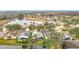 Community aerial view showcases homes nestled around a peaceful pond, surrounded by mature trees at 29523 Waggle Dr, San Antonio, FL 33576