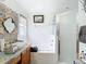 Elegant bathroom featuring decorative tile work, a glass shower, and a vanity with towels at 29523 Waggle Dr, San Antonio, FL 33576