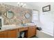 Stylish bathroom featuring a double sink vanity with unique tile work and modern fixtures at 29523 Waggle Dr, San Antonio, FL 33576