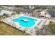 Aerial view of the community pool with ample seating and a central water feature, perfect for relaxation and recreation at 29523 Waggle Dr, San Antonio, FL 33576