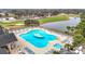 A scenic view of the community pool and hot tub area with golf course and lakes as a backdrop at 29523 Waggle Dr, San Antonio, FL 33576