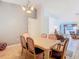 View of dining room, adjacent living room, with table, chairs, and chandelier at 29523 Waggle Dr, San Antonio, FL 33576