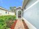 Charming front entrance with a decorative door and well-maintained landscaping at 29523 Waggle Dr, San Antonio, FL 33576