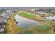 Picturesque aerial view of the golf course with ponds, perfect for golf enthusiasts and nature lovers at 29523 Waggle Dr, San Antonio, FL 33576
