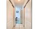 Hallway view leading to the bathroom with a vanity and a tub with a shower fixture at 29523 Waggle Dr, San Antonio, FL 33576