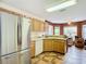 Open kitchen with stainless steel refrigerator and ample cabinet and counter space at 29523 Waggle Dr, San Antonio, FL 33576
