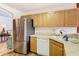 Spacious kitchen featuring stainless steel appliances and wooden cabinetry at 29523 Waggle Dr, San Antonio, FL 33576