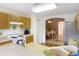 Well-lit kitchen featuring wooden cabinets and modern appliances overlooking an adjacent dining area at 29523 Waggle Dr, San Antonio, FL 33576