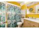 Bathroom featuring a shower with colorful marine themed curtain and nautical decor at 3624 Wiltshire Dr, Holiday, FL 34691