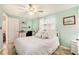 Comfortable bedroom with tile floors, ceiling fan, and a bright window at 3624 Wiltshire Dr, Holiday, FL 34691