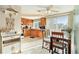 Open kitchen with wood cabinetry, tile flooring, and adjacent dining area at 3624 Wiltshire Dr, Holiday, FL 34691
