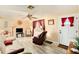 Cozy living room with tile floors, ceiling fan and front door access at 3624 Wiltshire Dr, Holiday, FL 34691