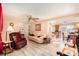 Inviting living room with tile floors, ceiling fan, and access to the kitchen at 3624 Wiltshire Dr, Holiday, FL 34691