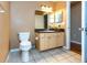 Bathroom featuring tiled floors, granite vanity top, and spacious mirror at 3673 Kings Rd # 102, Palm Harbor, FL 34685