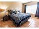 Comfortable bedroom featuring natural light, tiled floor, and cozy bedding at 3673 Kings Rd # 102, Palm Harbor, FL 34685