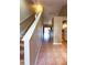 Hallway with wood-look stairs, tile flooring and access to kitchen and living area at 3673 Kings Rd # 102, Palm Harbor, FL 34685