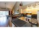 Bright kitchen with tiled floors, wooden cabinets, and a view into the living room at 3673 Kings Rd # 102, Palm Harbor, FL 34685
