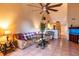 Inviting living room features high ceiling, ceiling fan, and tile flooring at 3673 Kings Rd # 102, Palm Harbor, FL 34685