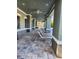 Covered patio featuring lounge chairs for relaxing poolside at 3673 Kings Rd # 102, Palm Harbor, FL 34685