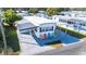 Aerial view of a mobile home with driveway and several colorful chairs at 37150 Sandra Ave, Zephyrhills, FL 33542