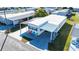 Aerial view of a mobile home with driveway and several colorful chairs at 37150 Sandra Ave, Zephyrhills, FL 33542