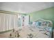 Comfortable bedroom featuring green walls, light carpet, and bamboo themed bedding at 37150 Sandra Ave, Zephyrhills, FL 33542