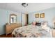 Cozy bedroom featuring a lovely dresser, nightstand, and decor at 37150 Sandra Ave, Zephyrhills, FL 33542