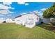 Exterior view of a white mobile home with lawn and partially clouded blue sky at 37150 Sandra Ave, Zephyrhills, FL 33542
