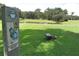 Well-maintained golf course with a clear marker, pond, and manicured green grass at 37150 Sandra Ave, Zephyrhills, FL 33542