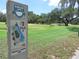Scenic golf course with marker indicating hole one, par three, featuring mature trees and pristine green grass at 37150 Sandra Ave, Zephyrhills, FL 33542