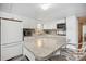 Bright kitchen featuring white cabinets, stainless steel appliances, and a granite countertop island at 37150 Sandra Ave, Zephyrhills, FL 33542
