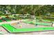 Fun miniature golf course surrounded by lush trees and landscaping at 37150 Sandra Ave, Zephyrhills, FL 33542