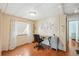 Bright home office featuring a desk, a comfortable chair, and wood floors at 37150 Sandra Ave, Zephyrhills, FL 33542
