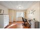 Bright office space with a dark desk, light walls, and wood-look flooring at 37150 Sandra Ave, Zephyrhills, FL 33542