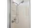 Standard shower and head with shelves for extra storage of items at 37150 Sandra Ave, Zephyrhills, FL 33542