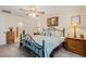 Comfortable bedroom featuring a decorative iron bed frame, ceiling fan, and classic furnishings at 3900 Autumn Amber Dr, Spring Hill, FL 34609