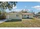 View of the backyard with partial fence, grass, and access door at 4101 W Leila Ave, Tampa, FL 33616