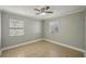 Cozy bedroom with two windows, ceiling fan, and tile floor, creating a serene and comfortable atmosphere at 4101 W Leila Ave, Tampa, FL 33616