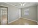 Bright bedroom features neutral walls, tile floor, ceiling fan, and window for a simple yet stylish look at 4101 W Leila Ave, Tampa, FL 33616