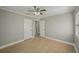 Bedroom with a ceiling fan, tile flooring, and doors, offering a spacious and functional design at 4101 W Leila Ave, Tampa, FL 33616