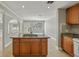 Kitchen area featuring tile flooring, an island with a sink, and neutral paint at 4101 W Leila Ave, Tampa, FL 33616