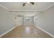 Open living room with tile flooring, neutral walls, and ceiling fan at 4101 W Leila Ave, Tampa, FL 33616