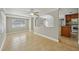Open-concept living room with tile flooring, fan, and access to kitchen at 4101 W Leila Ave, Tampa, FL 33616