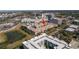 Community complex shown from above, with nearby office buildings, lush landscaping, and parking areas at 4221 W Spruce St # 1325, Tampa, FL 33607