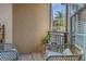 Relaxing balcony with wicker chairs, side table and a peaceful view at 4221 W Spruce St # 1325, Tampa, FL 33607