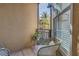 Relaxing balcony with wicker chairs, side table and a peaceful view at 4221 W Spruce St # 1325, Tampa, FL 33607