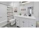 Well-lit bathroom offers a shower-tub combo and white vanity with a dark countertop at 4221 W Spruce St # 1325, Tampa, FL 33607